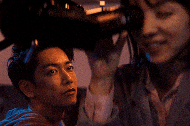 a man and a woman are looking at something together