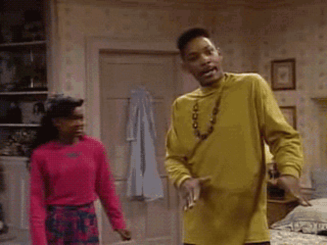 a man in a yellow shirt is dancing next to a woman in a pink sweater and the words mind ya business are visible