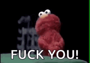 elmo from sesame street is sitting on a green surface and says `` fuck you '' .