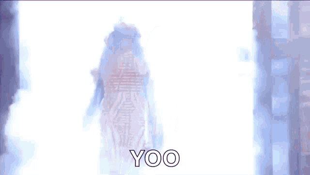 a woman in a white dress is walking through a doorway with the words yoo written on the bottom .