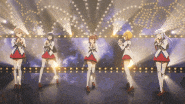 a group of anime girls standing on a stage