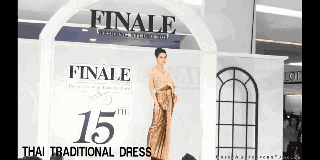 a woman is standing in front of a sign that says finale 15th