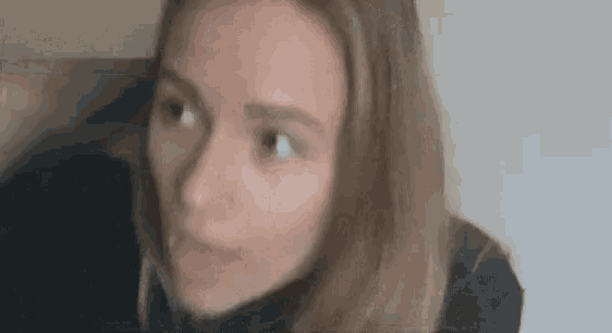 a close up of a woman 's face with her eyes closed .