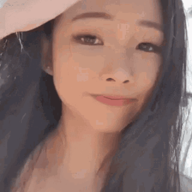 a close up of a woman 's face with her hand on her head