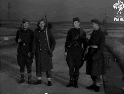a group of soldiers standing next to each other with the pathe logo in the background