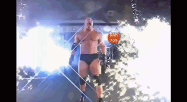 a wrestler is walking through a fire with a sign that says ram 70 %