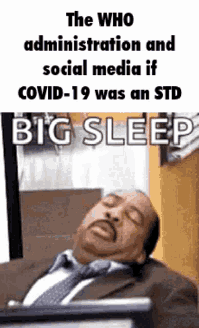 a man in a suit and tie is sleeping in front of a computer
