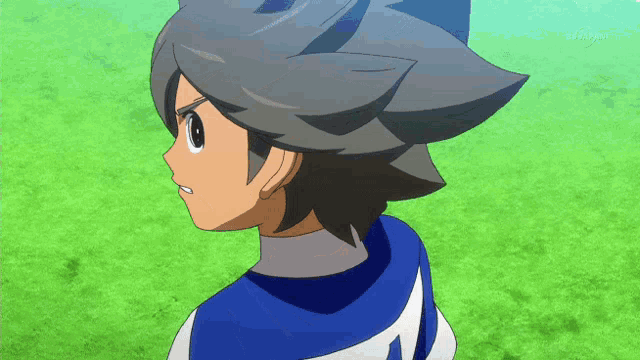 a boy in a blue and white uniform with the number 4 on the back