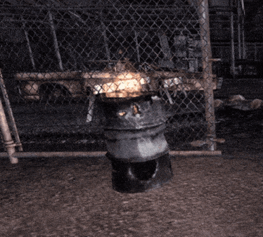 a metal barrel with a fire inside of it