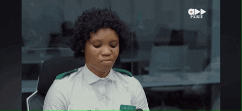 a woman in a white shirt with a name tag that says charles