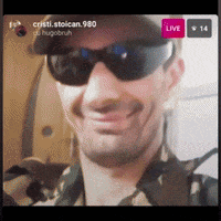 a man wearing sunglasses and a hat is smiling in a live broadcast