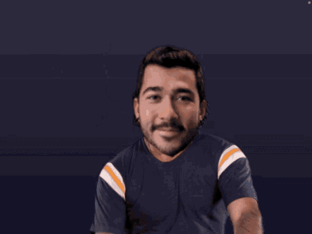 a man with long hair and a beard giving the middle finger