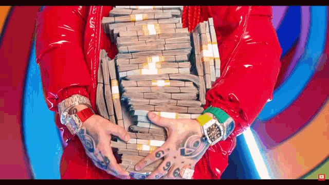 a man in a red jacket holds a stack of money
