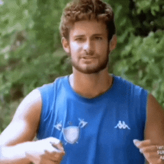 a man with a beard wearing a blue tank top with kappa on it .