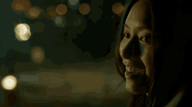 a close up of a woman 's face in the dark