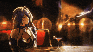 a gif of a woman sitting at a table with hsrgifs on the bottom right