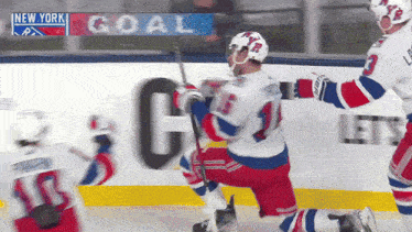 a hockey game is being played in new york and a goal is being celebrated