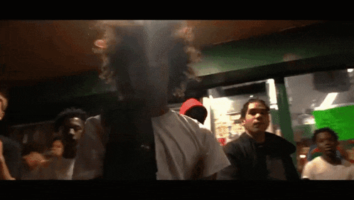 a group of people are standing in a dark room