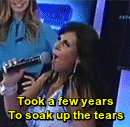 a woman singing into a microphone with the words took a few years to soak up the tears on the bottom