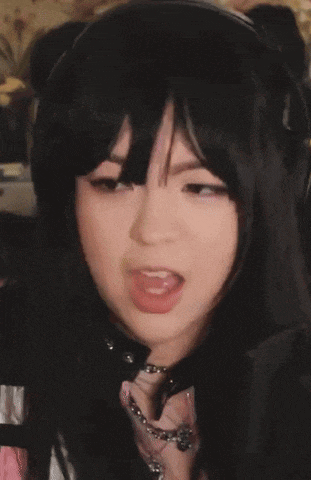 a girl wearing headphones says " oh fuck no " in red letters