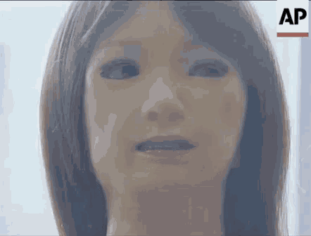 a close up of a robot 's face with a serious look on her face .