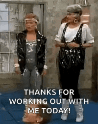 a couple of women are standing next to each other on a mat .