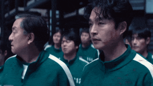 a man in a green jacket with the number 15 on the front