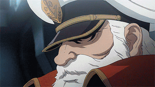 a man with a beard is wearing a hat with a gold emblem on it