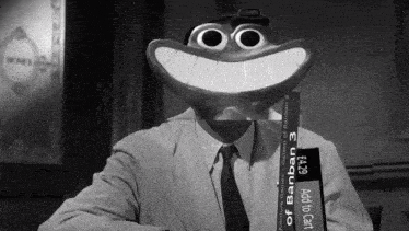 a man in a suit and tie is holding a stack of banban 3