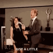 a man in a suit and tie is holding a woman in a black dress while they are dancing .