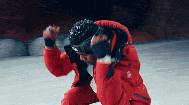 a man wearing a red jacket and a headband that says nfd on it