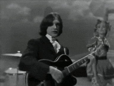 a man is playing a guitar in a black and white photo