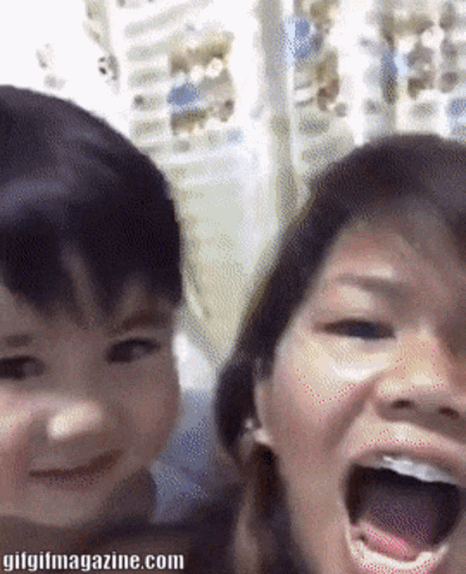 a gif of a woman and a child with the website gifgifmagazine.com in the bottom right corner