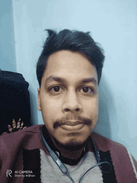 a man with a beard is wearing a pair of headphones that say ' ioi ' on them