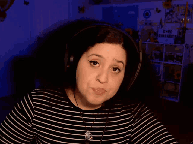a woman wearing headphones and a striped shirt