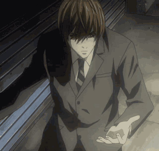 a man in a suit and tie is standing in the dark