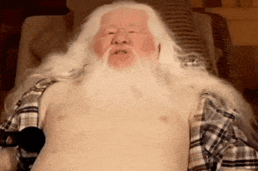 a man with long white hair and a beard without a shirt