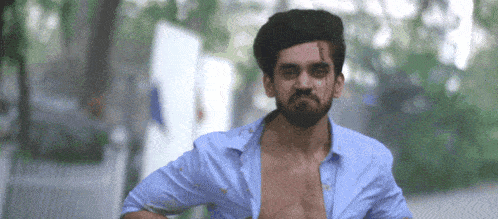 a man without a shirt is running down a street .