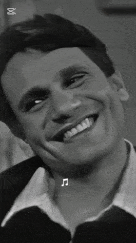 a black and white photo of a man smiling