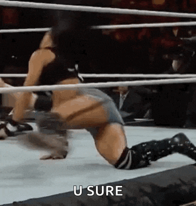 a woman is kneeling in a wrestling ring with the words `` u sure '' written next to her .