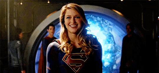 a woman wearing a superman costume is smiling