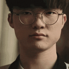 a close up of a young man wearing glasses
