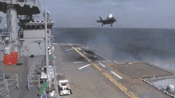 a close up of a fighter jet taking off from a runway .