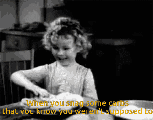 a black and white photo of a little girl with the words when you snag some carbs that you know you weren 't supposed