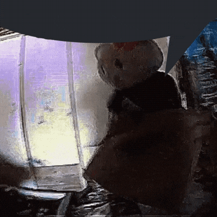 a person is holding a hello kitty stuffed animal in front of a purple light .