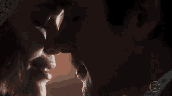 a close up of a man and woman kissing with a circle in the corner