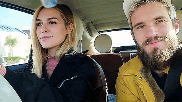 a man and a woman are sitting in a car