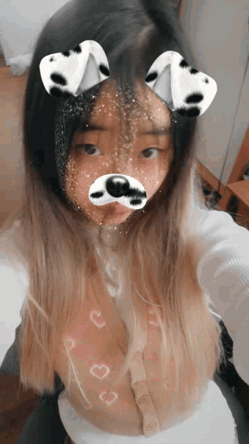 a girl wearing a dalmatian mask takes a selfie