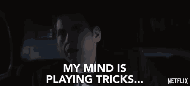a man in a suit and tie is sitting in the back seat of a car and says my mind is playing tricks .