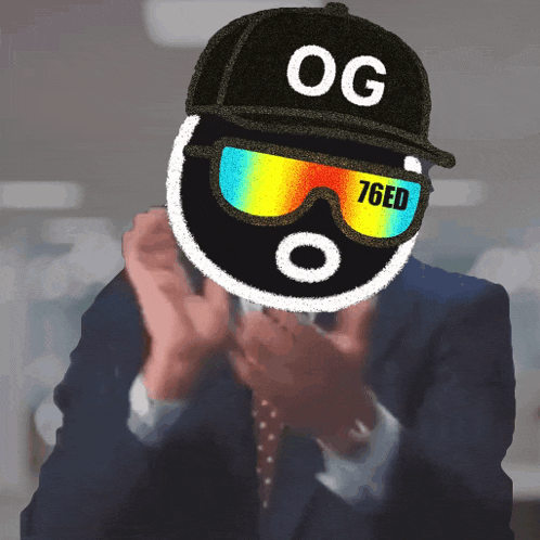 a man in a suit and tie is wearing a hat that says og 76ed